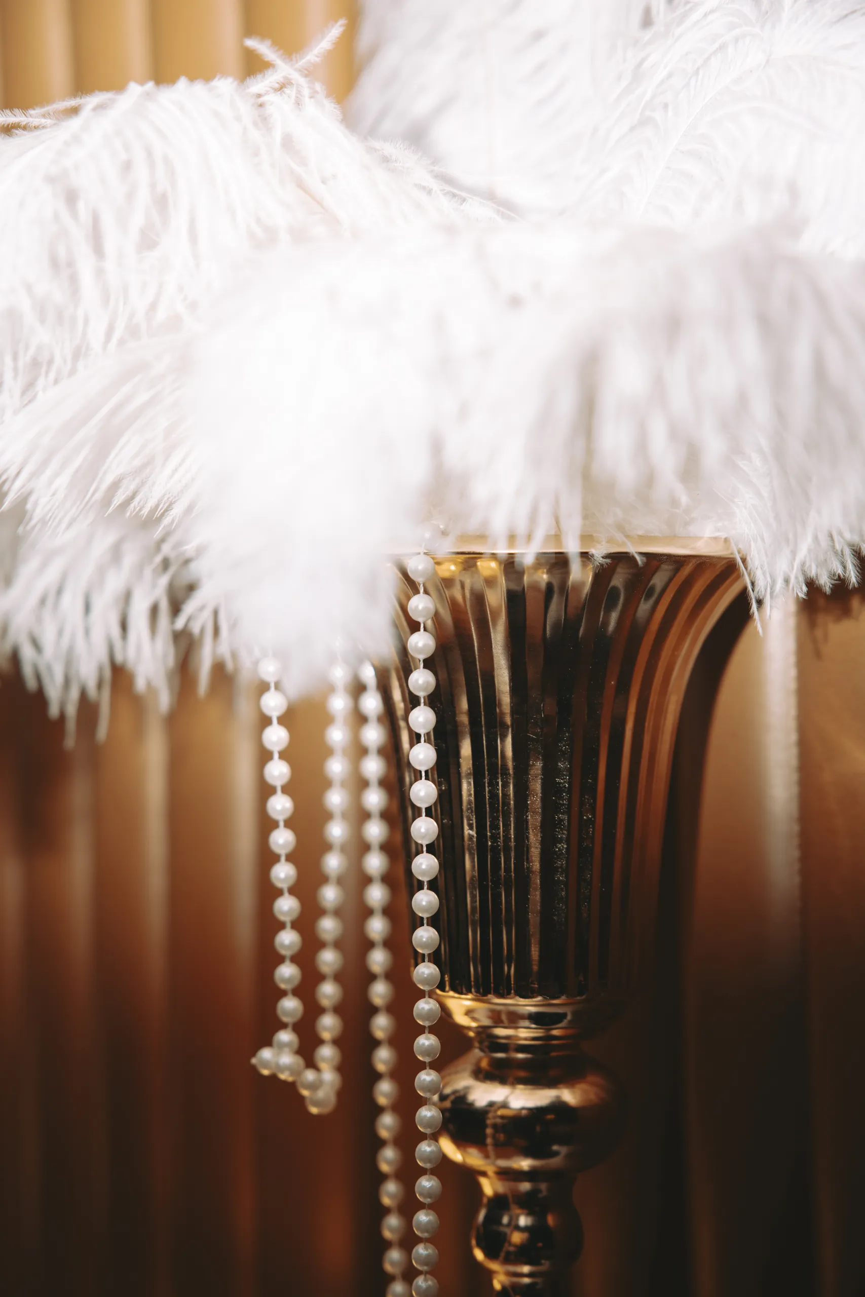 New Year Party Baker McKenzie - centre de table en plumes d'autruche blanches et colliers de perles par Event Machine