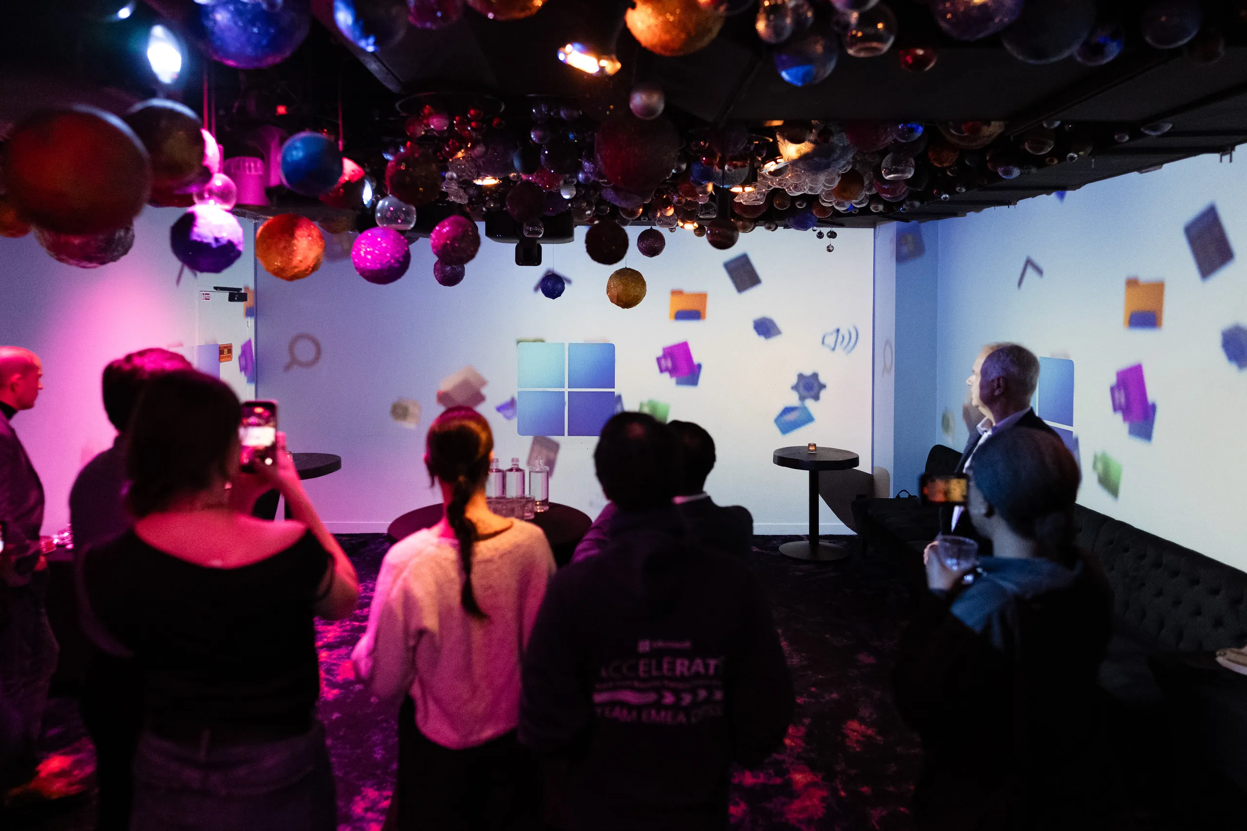 Soirée de lancement Microsoft - groupe d'invités souriants verre à la main sous le plafond de planètes par Event Machine